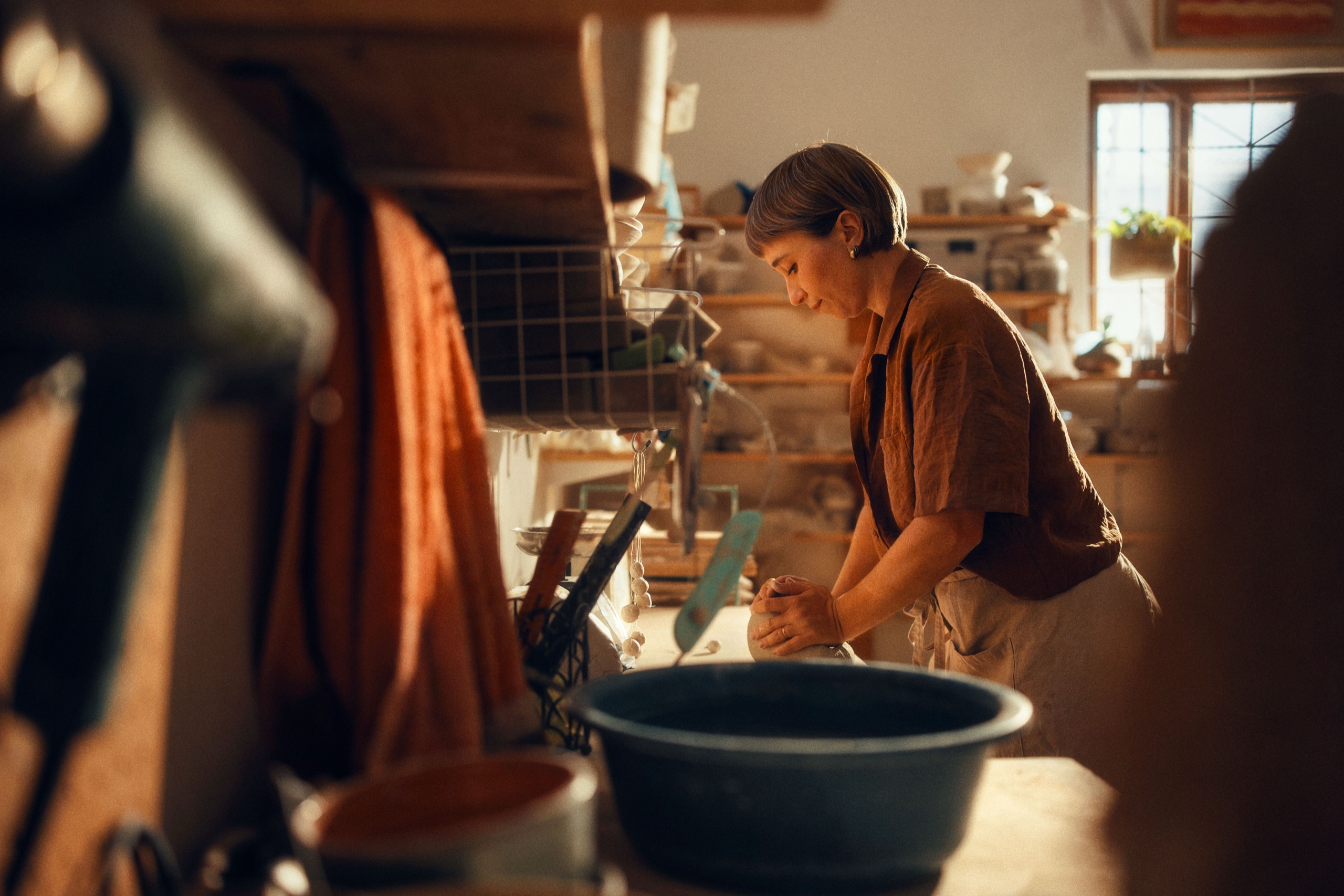 Top-down view of hands at work in clay