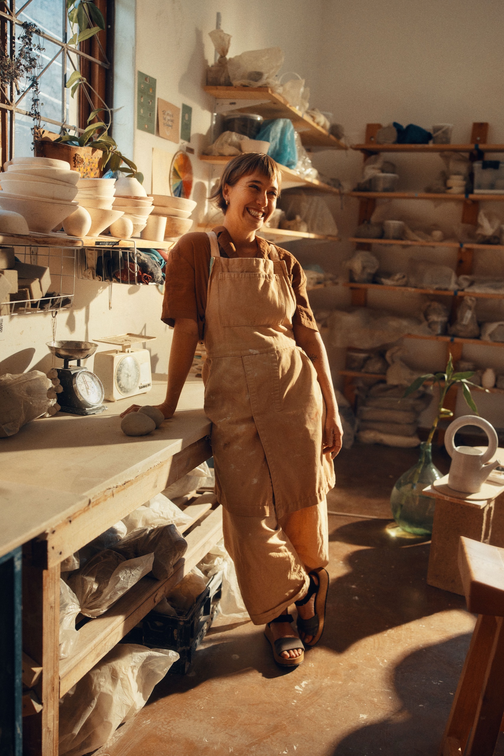 The potter shaping a tall vessel